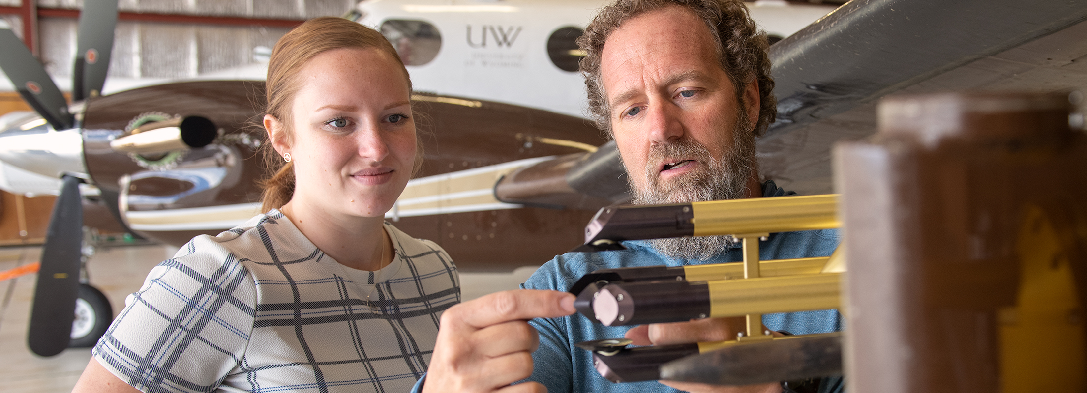 A faculty meber guides a student in instrument research at the UW-Flight Center