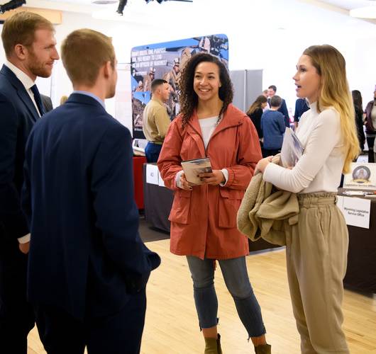 students speaking with employers at a career fair