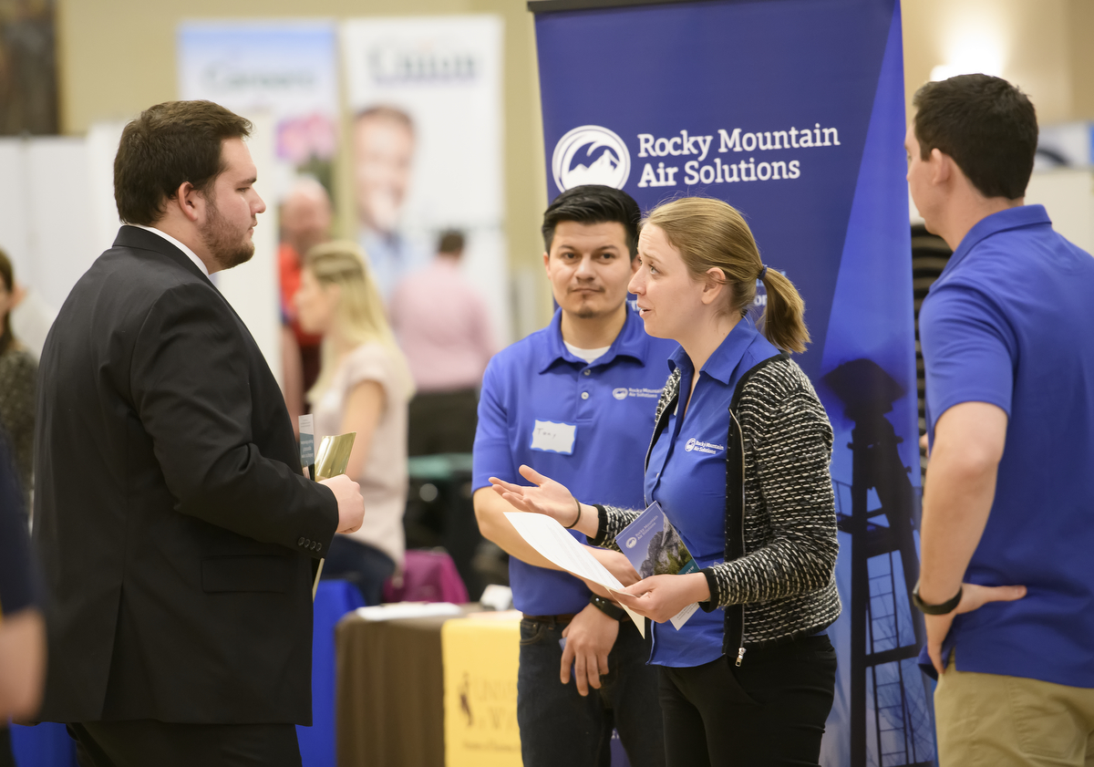 students speaking with employers at a career fair