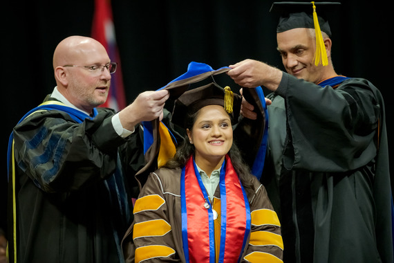graduate student receiving diploma
