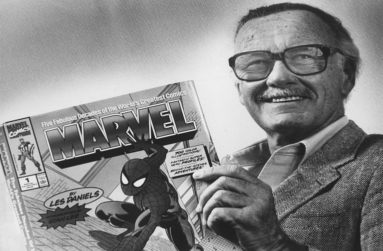 Stan Lee holding a Marvel comic