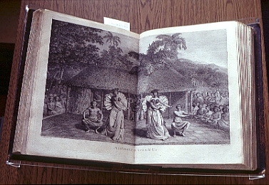 Black ink sketch across two pages of a book of 2 native men and 2 native woman dancing in fornt of a hut house with crowd of onlookers seated.  