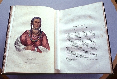 Inside book page image of color ink sketch of native woman with braides, necklace ornimants, bracelt, red dress shirt and white shawl