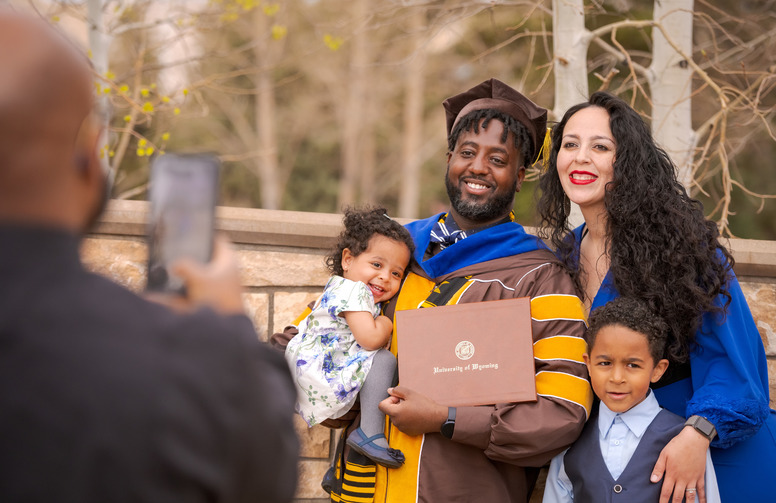 a student and their family at commencement 