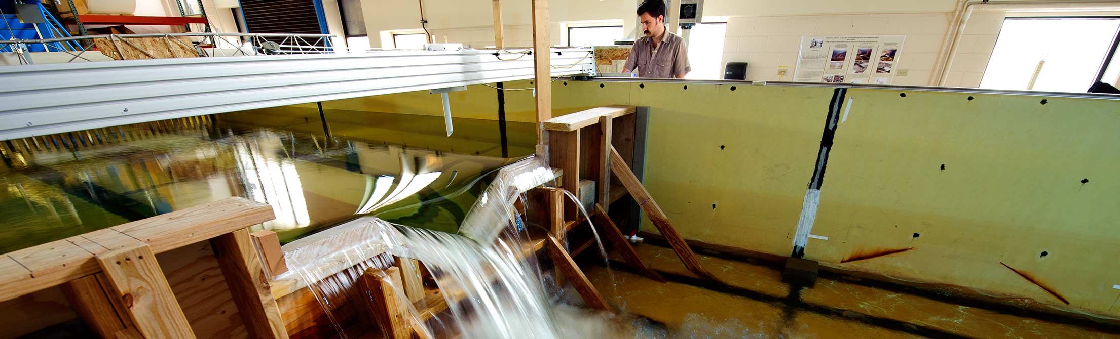 Man watches water flow in engineering resources lab
