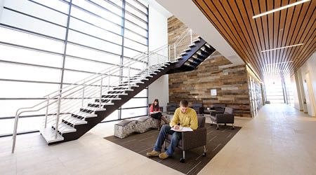 students are pictured inside the energy innovation center with a broad staircase and comfortable furniture.