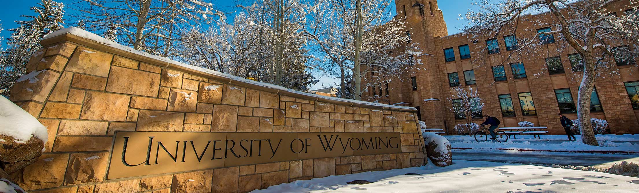 University of Wyoming stonework sign with Wyoming Union in the background