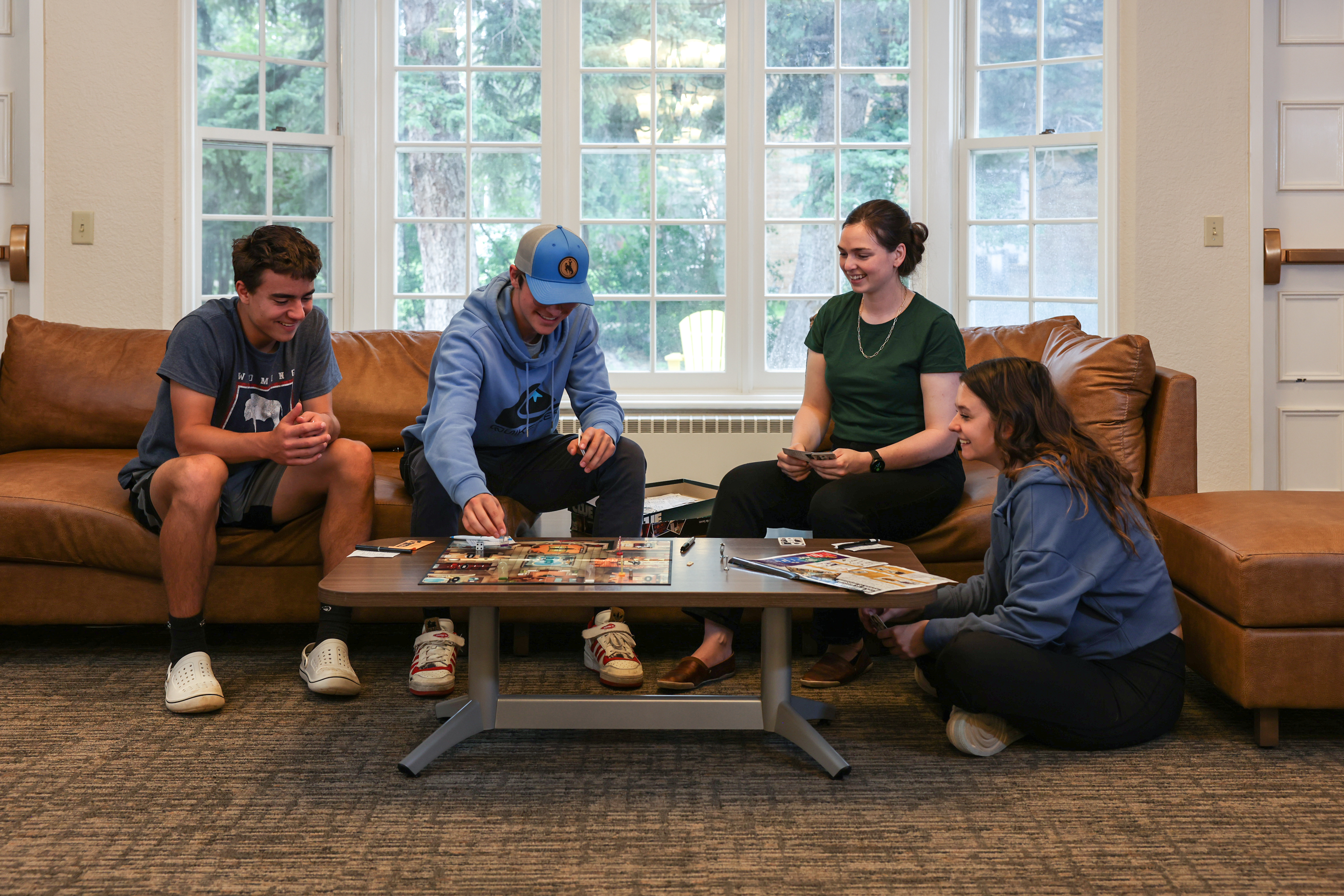 group playing board game in tobin house