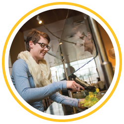 Student filling a plate of salad at Washakie Dining Center