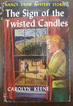 illustrated cover of a Nancy Drew mystery book