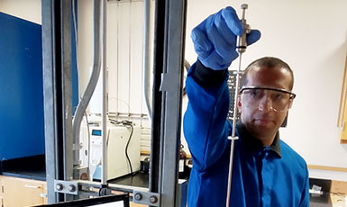 man using equipment in a lab
