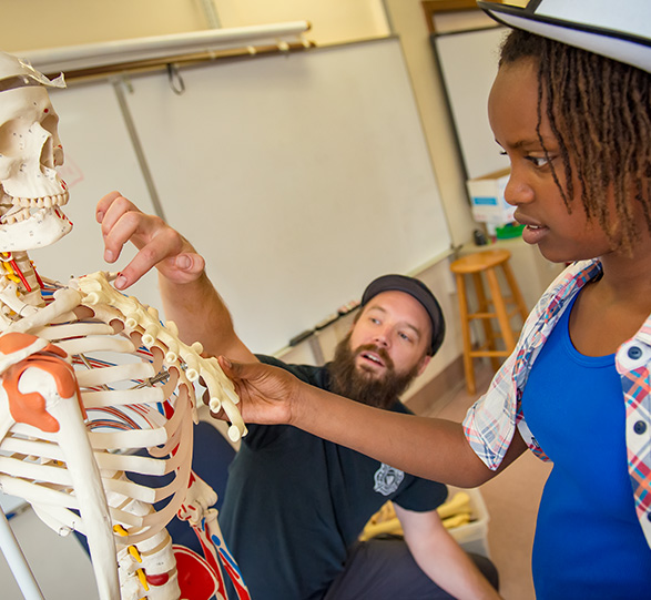 Teacher and Student touching a skeleton