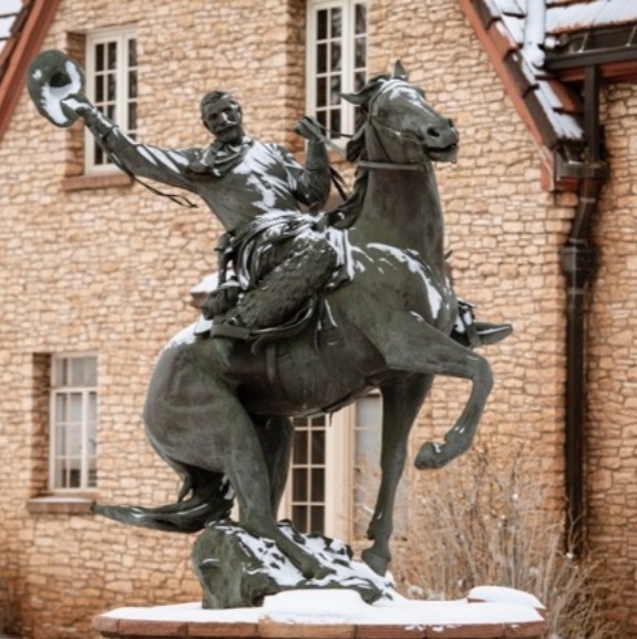 Statue of man on horse in the snow