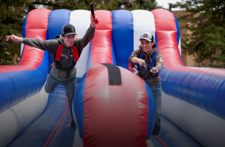 Two students playing on inflatable during Union Fest
