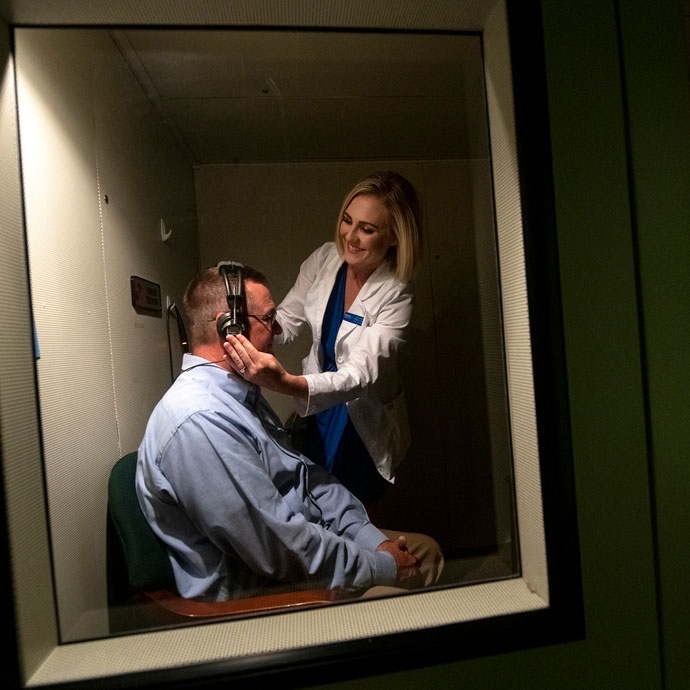 Audiologist working with client