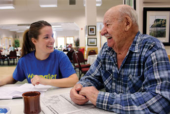 young woman talking with elderly man