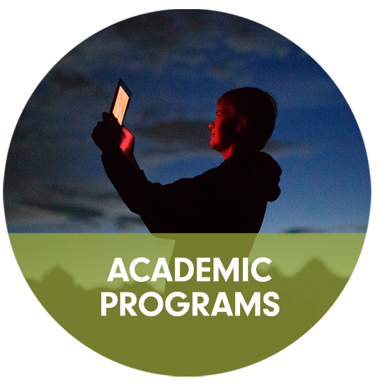 Academic Programs callout with picutre of student looking at night sky through iPad